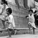 kids running in Varanasi India black and white photo