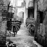 silk on bikes in Varanasi India black and white