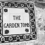 sign at the entrance of the garden tomb of jesus in Jerusalem, photo in black and white