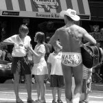 Naked Cowboy playing guitar in Times Square, New York City NYC USA in black and white
