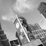 black and white photo of new york buildings and advertisements