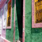 colorful houses painted in green, bink , yellow and orange in Olinda Brazil