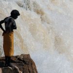 a local man is watching at the current of the Narmada river at Marble Rocks in India