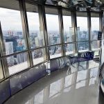 inside the tokyo tower at the top deck with Tokyo city view in the background
