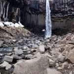 Svartifoss waterfall by dark lava columns in Iceland