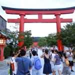 tourists walking towards the Fushimi Inari Shrine in Kyoto Japan