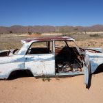 a blue abandoned car in the Namib Desert at the Solitaire gas station and Bakery