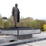the giant lego of 4 meters high behind a statue of Ibrahim Rugova in Pristina Kosovo