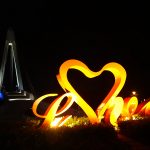 a sign of LOVE with the Lover bridge in the background in Tamsui fishermen's wharf just outside Taipei, Taiwan